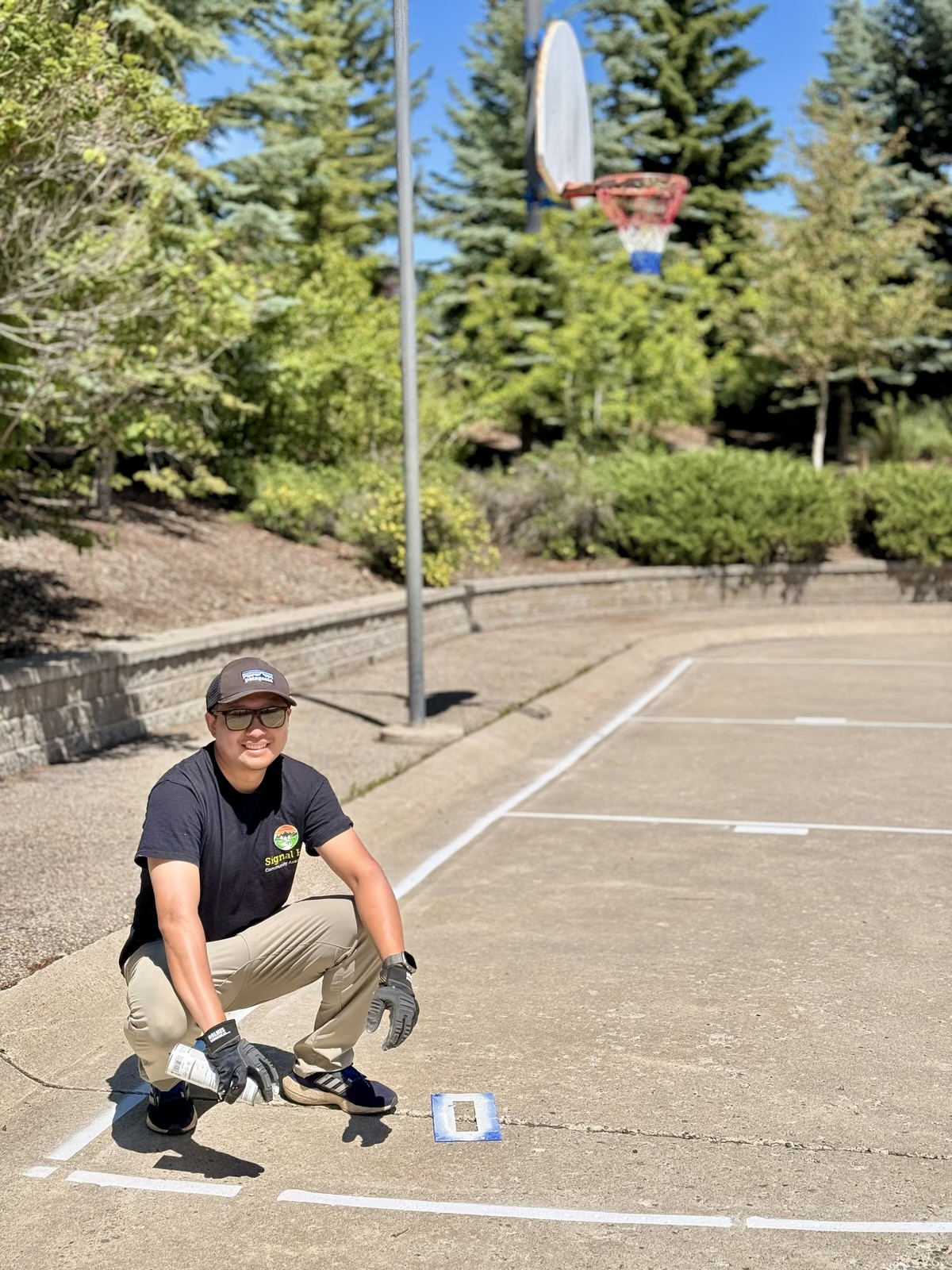 Chen re-lining the basketball courts at Signal Hill Community Association